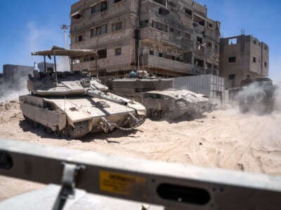 Israeli tanks are seen next to destroyed buildings during a ground operation in the southern Gaza Strip on July 3, 2024.