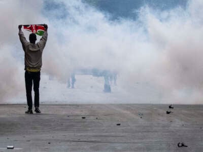 A protestor holds the Kenya flag during a demonstration against the government in Nairobi, on August 8, 2024.