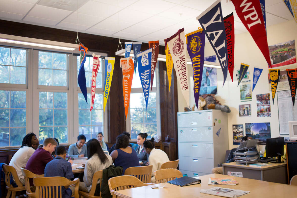 Students sit around a table in a library