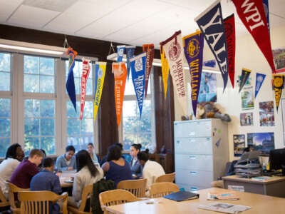 Students sit around a table in a library