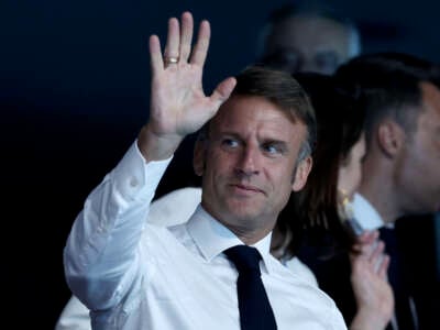 French President Emmanuel Macron waves as he is seen in attendance on day seven of the Olympic Games Paris 2024 at Paris La Defense Arena on August 2, 2024, in Nanterre, France.