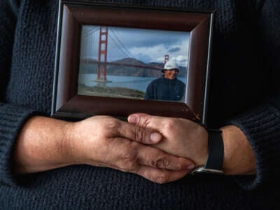 Sandra Muñoz, a celebrated civil rights attorney in Los Angeles, holds a photo of her husband Luis on January 3, 2024, in Los Angeles, California.