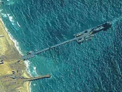 U.S. Army Soldiers assigned to the 7th Transportation Brigade (Expeditionary), U.S. Navy Sailors assigned to Amphibious Construction Battalion 1, and Israel Defense Forces emplace the Trident Pier, May 16, 2024, on the Gaza coast.