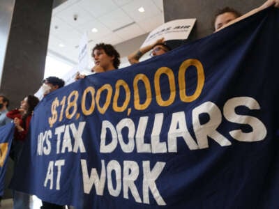 A banner reads: $18,000,000 NYS Tax Dollars at Work, during a demonstration at Atlas Air’s headquarters