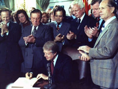 Jimmy Carter signs the Airline Deregulation Act of 1978 on October 24, 1978.