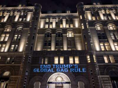 A projection is seen as activists from the Population Connection Action Fund project a message onto the Trump International Hotel, to protest the Global Gag Rule which bans health care providers that receive U.S. global health aid from referring, providing or discussing abortion with their patients, during a demonstration in Washington, D.C. on January 23, 2019.