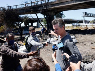 California Governor Gavin Newsom speaks with media while participating in a sweep at a long-standing homeless encampment along Highway 80 on August 9, 2021, in Berkeley, California.