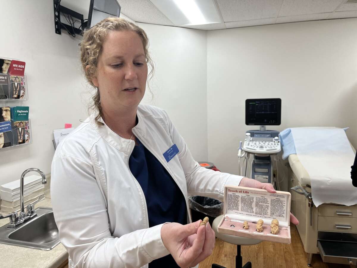 A nurse at a pregnancy crisis center run by the Christian faith-based non-profit Wellspring Life Ministry in Severna Park, Maryland, shows a model of a human embryo in the early stages of pregnancy while speaking to AFP on June 13, 2023.