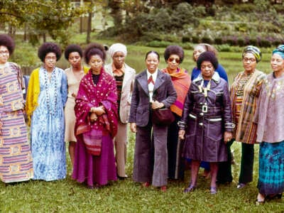 From left to right: Malaika Wangara, Linda Brown Bragg, Carole Gregory Clemmon, Alice Walker, Mari Evans, Gloria Oden, June Jordan, Marion Alexander, Margaret Danner, Audre Lorde and Margaret Goss Burrough, participants of The Phillis Wheatley Poetry Festival standing in a garden.