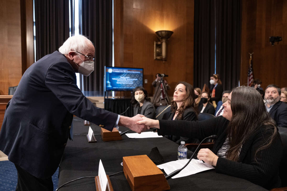 Committee chairman Sen. Bernie Sanders shakes hands with long COVID patient Nicole Heim as he arrives for a Senate Committee on Health, Education, Labor and Pensions hearing titled "Addressing Long COVID: Advancing Research and Improving Patient Care" on January 18, 2024, in Washington, D.C.