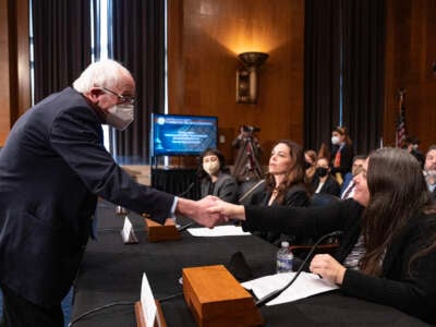 Committee chairman Sen. Bernie Sanders shakes hands with long COVID patient Nicole Heim as he arrives for a Senate Committee on Health, Education, Labor and Pensions hearing titled "Addressing Long COVID: Advancing Research and Improving Patient Care" on January 18, 2024, in Washington, D.C.