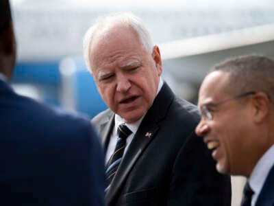 Minnesota Governor Tim Walz awaits the arrival of U.S. Vice President Kamala Harris at the Minneapolis-St. Paul International Airport in Saint Paul, Minnesota, on March 14, 2024.