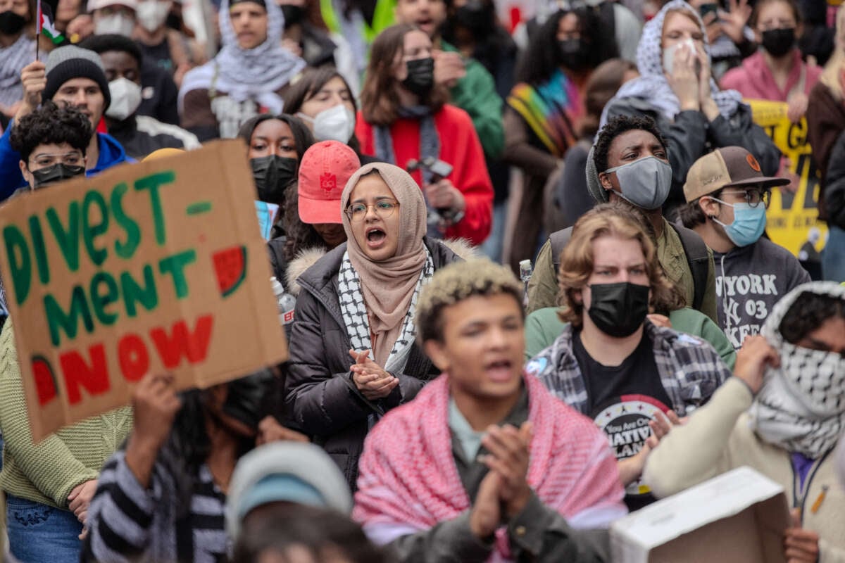 Students chant slogans during the pro-Palestine student protest and encampment at George Washington University's Yard, demonstrating against Israeli military action in Gaza and calling on their university to stop doing business with companies they see as supporting the genocide on April 27, 2024.