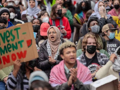 Students chant slogans during the pro-Palestine student protest and encampment at George Washington University's Yard, demonstrating against Israeli military action in Gaza and calling on their university to stop doing business with companies they see as supporting the genocide on April 27, 2024.