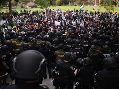 Police clear pro-Palestinian demonstrators off the campus stairs into a grassy area after students occupied the Physical Sciences Lecture Hall at the University of California, Irvine, in Irvine, California, on May 15, 2025. Police clear pro-Palestinian demonstrators off the campus stairs into a grassy area after students occupied the Physical Sciences Lecture Hall at the University of California, Irvine, in Irvine, California, on May 15, 2024.