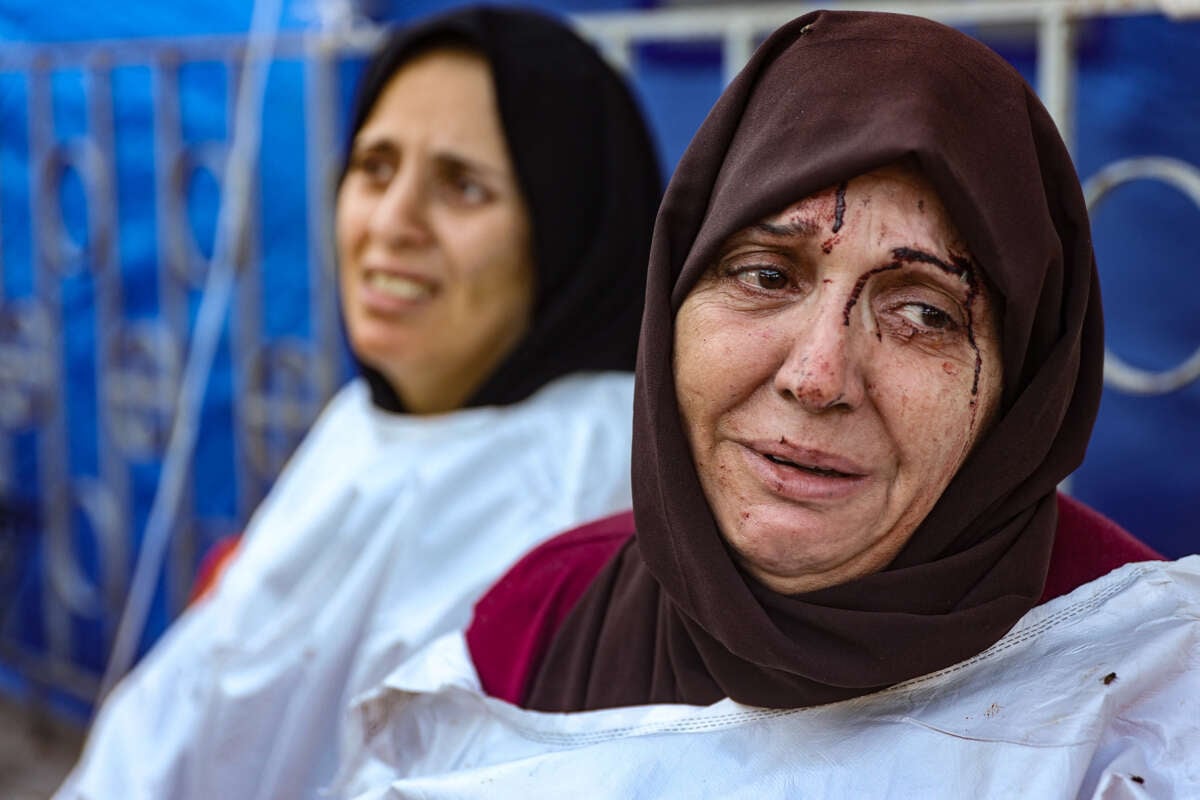 An injured woman reacts after identifying a member of her family among the dead at the al-Maamadani hospital, following an Israeli strike that killed more than 90 people on a school sheltering displaced Palestinians in Gaza City, on August 10, 2024.