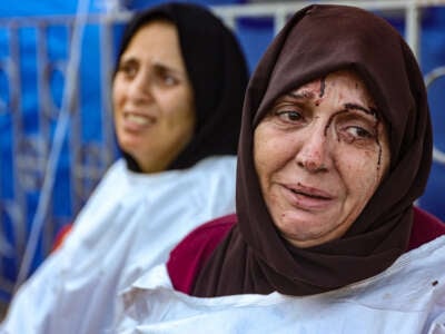 An injured woman reacts after identifying a member of her family among the dead at the al-Maamadani hospital, following an Israeli strike that killed more than 90 people on a school sheltering displaced Palestinians in Gaza City, on August 10, 2024.