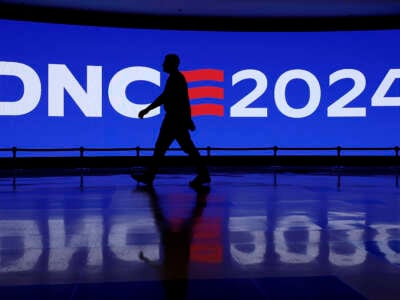 A man walks by a Democratic National Convention 2024 sign at the United Center on August 18, 2024, in Chicago, Illinois.