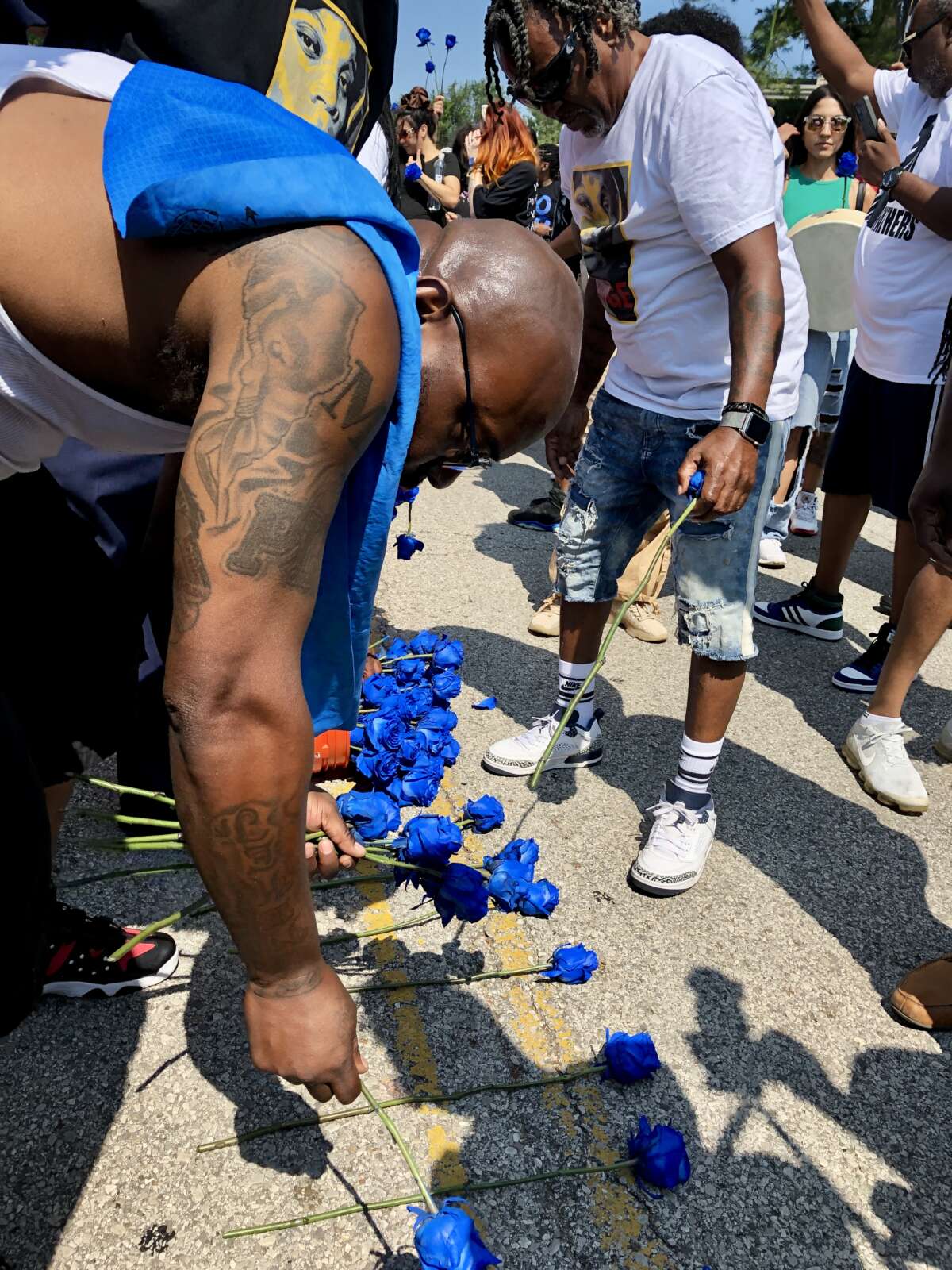 Mike Brown Sr. places royal blue roses near the grassroots memorial for his son on Canfield Dr. in Ferguson, Missouri, on August 9, 2024.