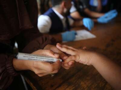 A health worker marks the finger of a Palestinian child vaccinated against polio in Deir el-Balah in the central Gaza Strip, on September 1, 2024, amid Israel's ongoing war on Gaza.