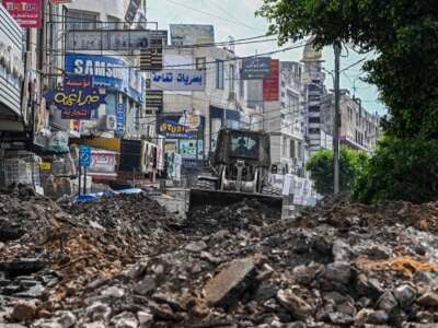 An Israeli bulldozer tears up a street during an Israeli raid in the occupied West Bank city of Jenin on September 1, 2024.