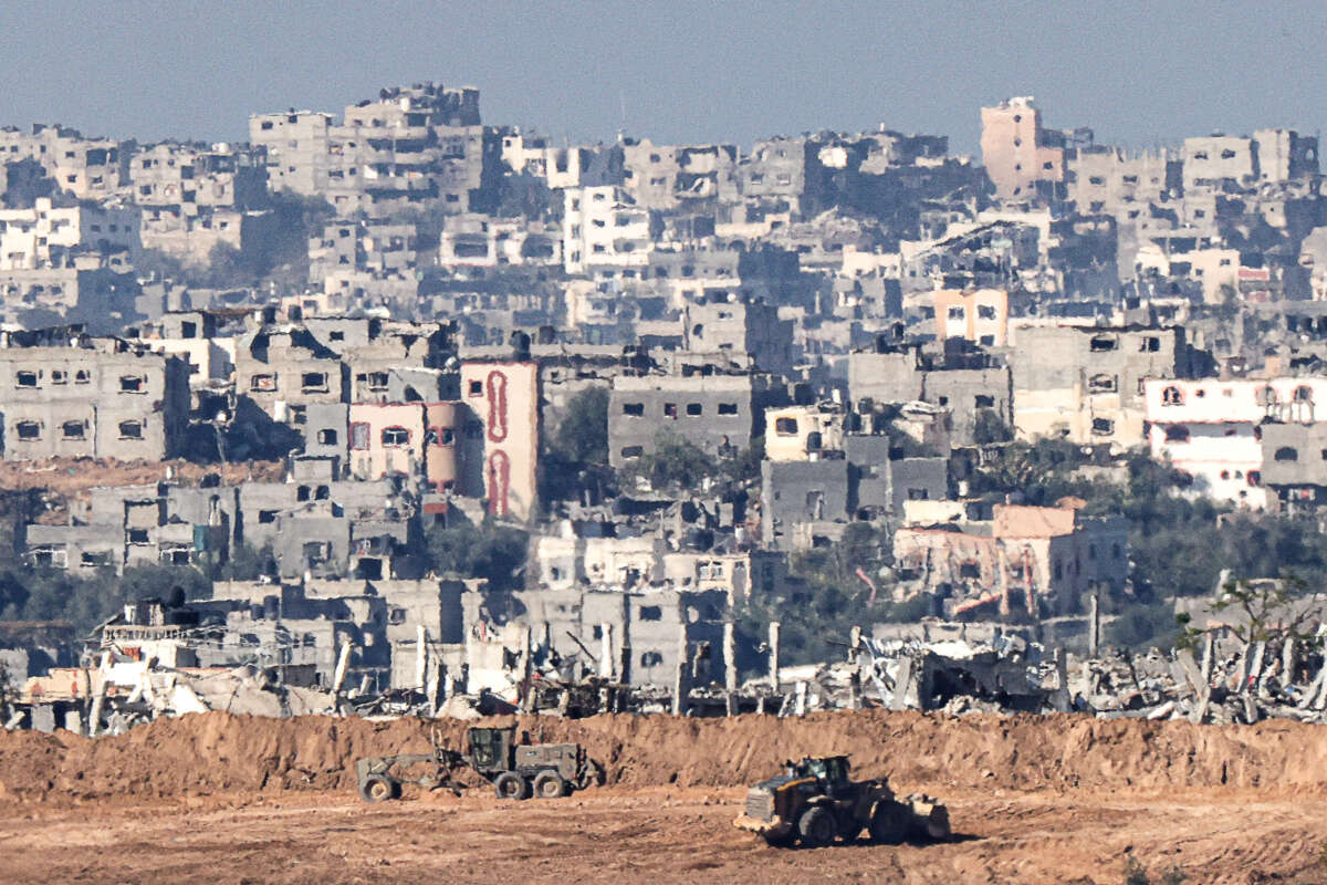 A picture taken in southern Israel near the border with the Gaza Strip on December 15, 2023, shows Israeli military bulldozers working in northern Gaza.