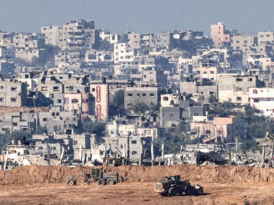 A picture taken in southern Israel near the border with the Gaza Strip on December 15, 2023, shows Israeli military bulldozers working in northern Gaza.