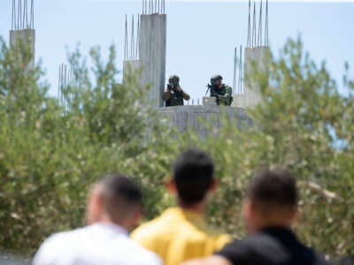 Israeli soldiers face Palestinian protesters in the town of Beita, West Bank, on August 9, 2024.