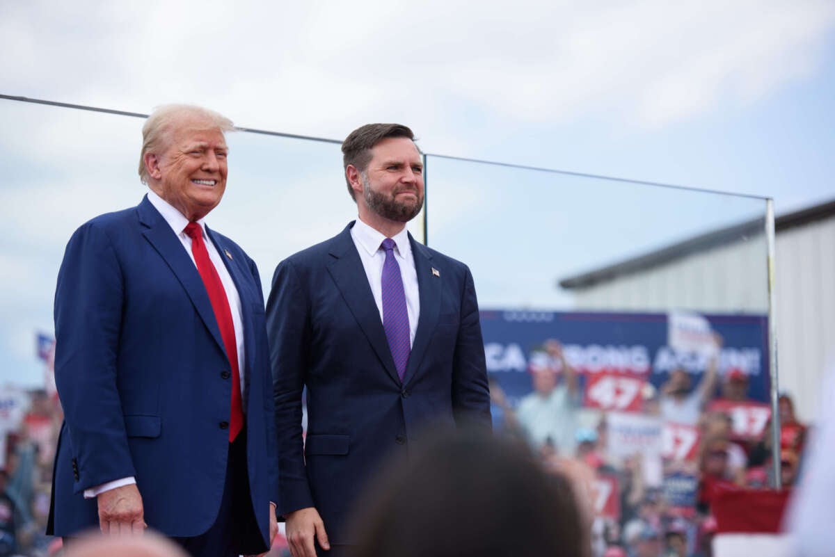 Republican presidential candidate, former President Donald Trump, left, poses for photos with Republican vice presidential candidate, Sen. J.D. Vance, before making remarks to a crowd during an event on August 21, 2024, in Asheboro, North Carolina, at the North Carolina Aviation Museum and Hall of Fame.