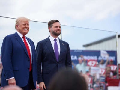 Republican presidential candidate, former President Donald Trump, left, poses for photos with Republican vice presidential candidate, Sen. J.D. Vance, before making remarks to a crowd during an event on August 21, 2024, in Asheboro, North Carolina, at the North Carolina Aviation Museum and Hall of Fame.