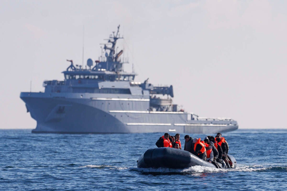 An inflatable dinghy carrying migrants is escorted by a French Warship across the English Channel towards British Waters on March 6, 2024.