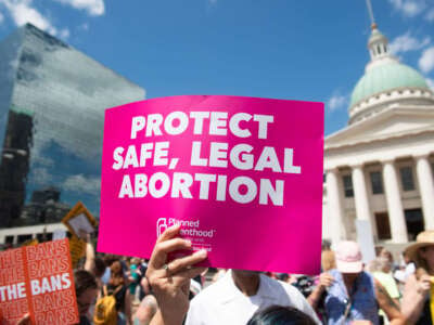 Protesters hold signs as they rally in support of Planned Parenthood and abortion rights, near the Old Courthouse in St. Louis, Missouri, on May 30, 2019.