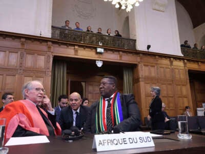 South African Ambassador to the Netherlands Vusimuzi Madonsela and members of the delegation sit in the courtroom of the International Court of Justice (ICJ) in The Hague, the Netherlands, on May 24, 2024.