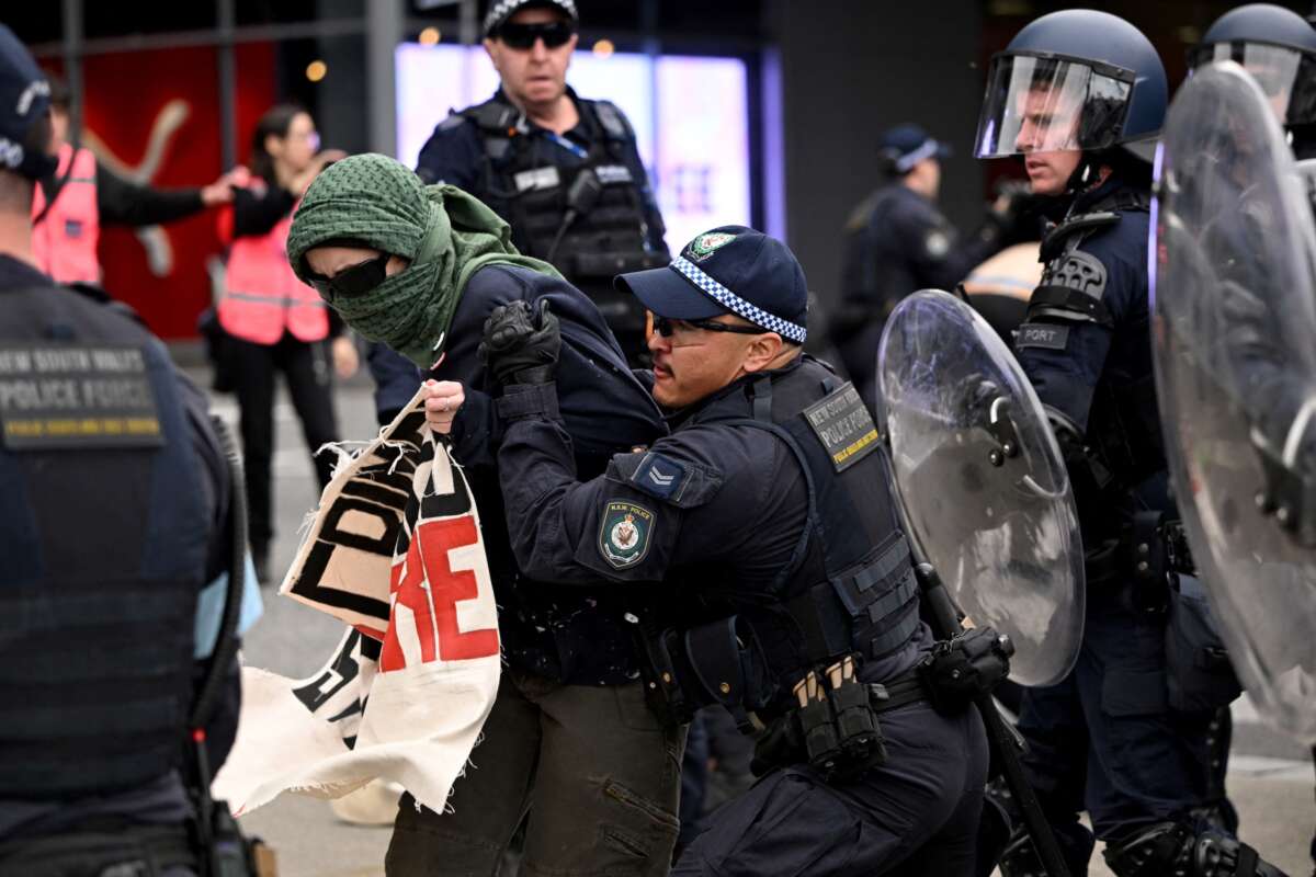 A police officer grabs an antiwar demonstrator outside the Land Forces 2024 arms fair in Melbourne, Australia, on September 11, 2024.