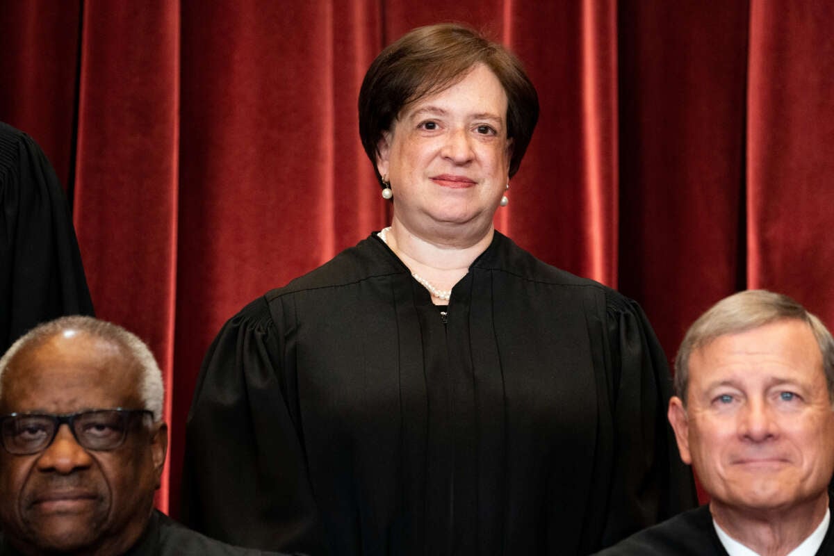 Associate Justice Elena Kagan, with Associate Justice Clarence Thomas and Chief Justice John Roberts in front of her, stands during a group photo of the Justices at the Supreme Court in Washington, D.C., on April 23, 2021.