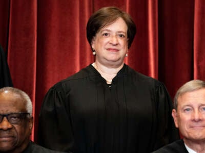 Associate Justice Elena Kagan, with Associate Justice Clarence Thomas and Chief Justice John Roberts in front of her, stands during a group photo of the Justices at the Supreme Court in Washington, D.C., on April 23, 2021.