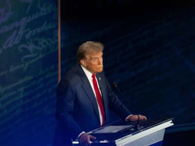 Former President Donald Trump reacts as Vice President Kamala Harris speaks during the first presidential debate at National Constitution Center in Philadelphia, Pennsylvania, on September 10, 2024.