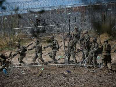 U.S. authorities shoot rubber bullets at migrants after migrants tried to cut the razor wire fences put up by the Texas National Guard to make it more difficult for them to cross at the U.S. border, on March 22, 2024, in Ciudad Juarez, Mexico.