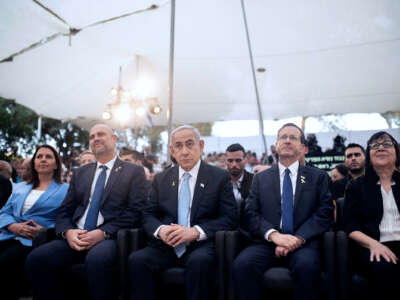 Benjamin Netanyahu and members of the Israeli Knesset sit at an event