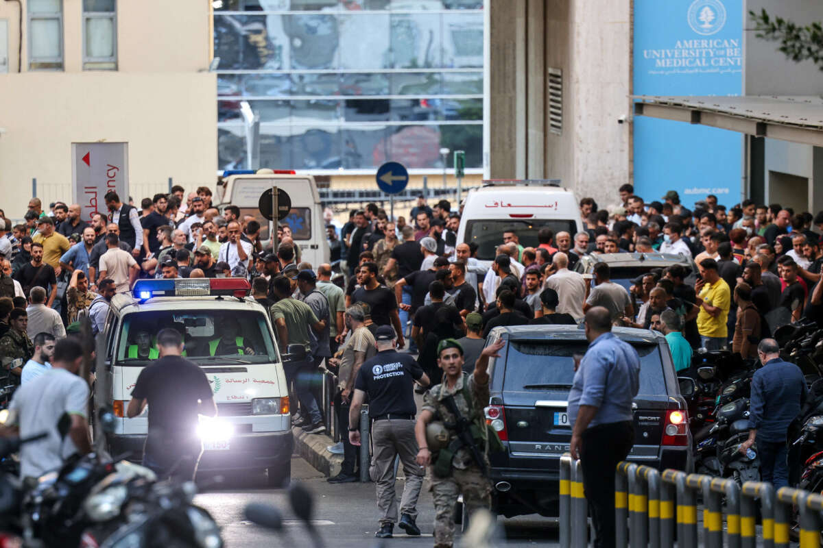 Ambulances are surrounded by people at the entrance of the American University of Beirut Medical Center, on September 17, 2024.