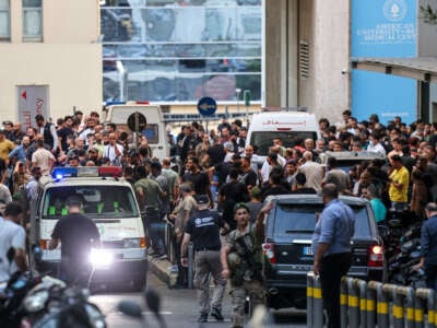 Ambulances are surrounded by people at the entrance of the American University of Beirut Medical Center, on September 17, 2024.