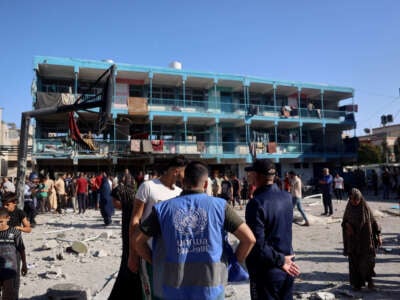 A member of the United Nations Relief and Works Agency for Palestine Refugees (UNRWA) checks the courtyard of the Al-Jawni (Jaouni) school after an Israeli air strike hit the site, in Nuseirat in the central Gaza Strip on September 11, 2024.