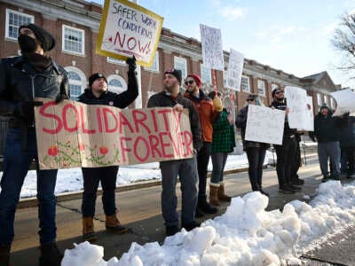 Postal workers picket outside the post office on Forest Ave. in Portland, Maine, on December 18, 2022.