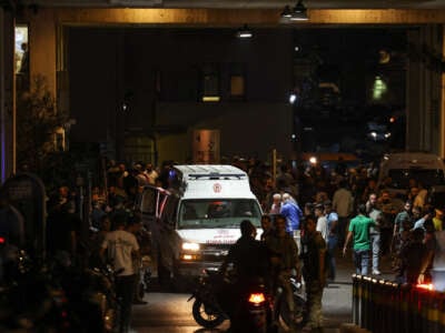 Ambulances are surrounded by people at the entrance of the American University of Beirut Medical Center, on September 17, 2024, after explosions hit locations in several Hezbollah strongholds around Lebanon amid ongoing cross-border tensions between Israel and Hezbollah fighters.