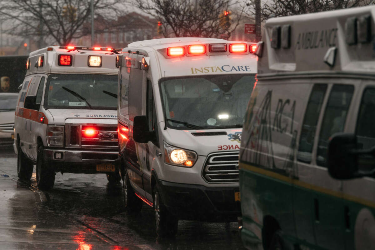 Parked ambulances flash their lights near Brookdale University Hospital and Medical Center in Brooklyn, New York, on April 13, 2020.