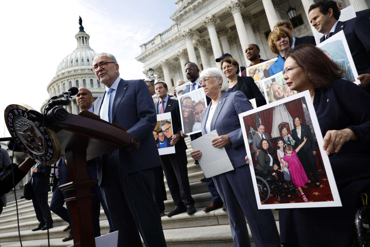 Senate Majority Leader Charles Schumer speaks alongside fellow Democrats holding photos of familles that have benefited from IVF treatment during a press conference on the Right to IVF Act, outside of the U.S. Capitol on September 17, 2024, in Washington, D.C.