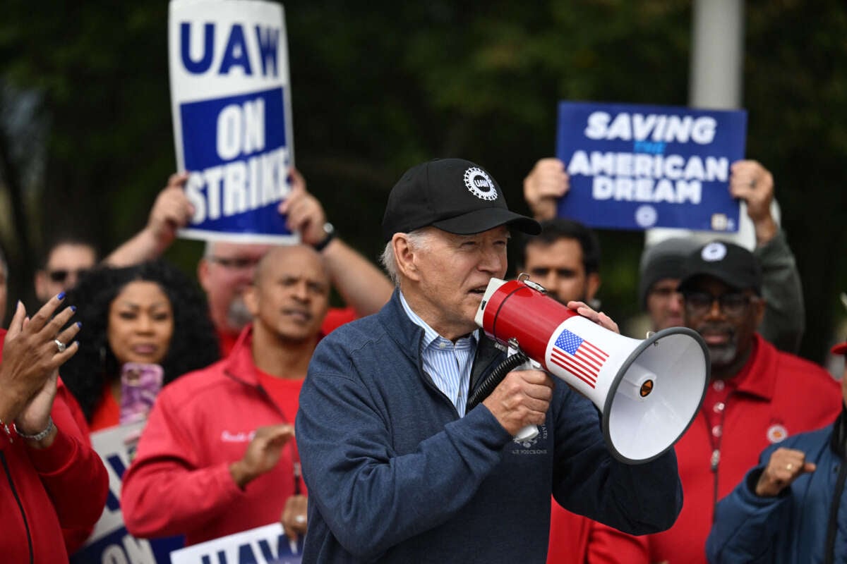 President Joe Biden addresses striking members of the United Auto Workers (UAW) union at a picket line outside a General Motors service parts operations plant in Belleville, Michigan, on September 26, 2023.