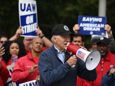 President Joe Biden addresses striking members of the United Auto Workers (UAW) union at a picket line outside a General Motors service parts operations plant in Belleville, Michigan, on September 26, 2023.