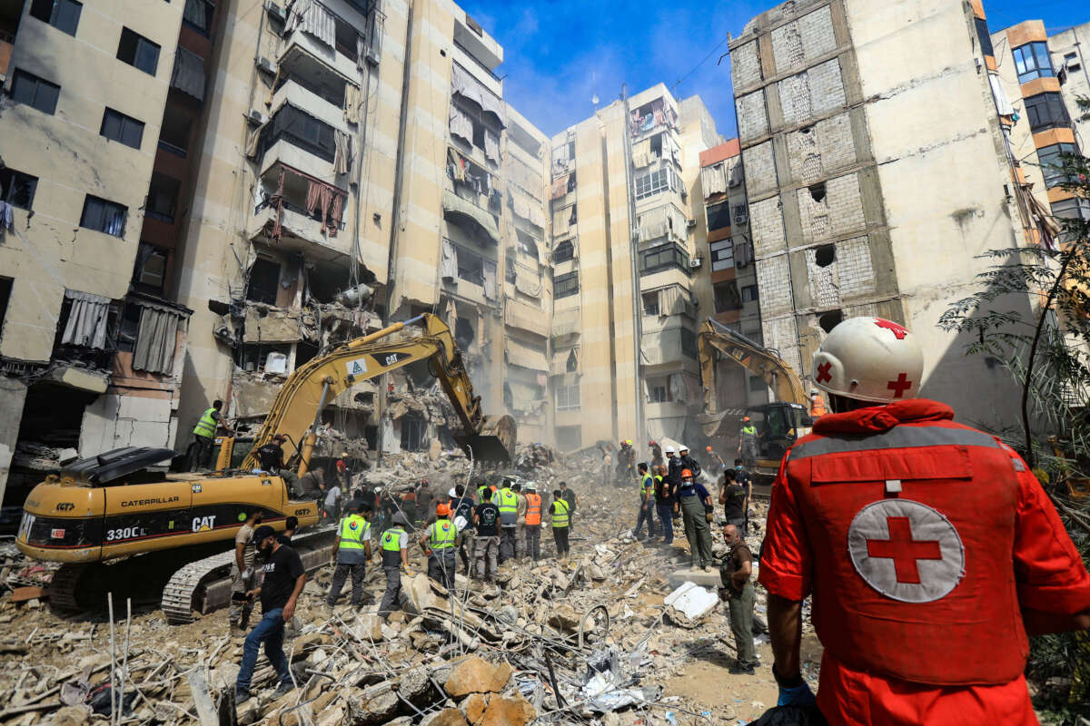 Rescuers sift through the rubble at the scene of an Israeli strike that targeted Beirut's southern suburbs a day earlier, as search and rescue operations continue on September 21, 2024.