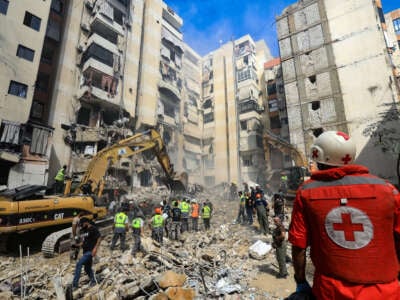 Rescuers sift through the rubble at the scene of an Israeli strike that targeted Beirut's southern suburbs a day earlier, as search and rescue operations continue on September 21, 2024.